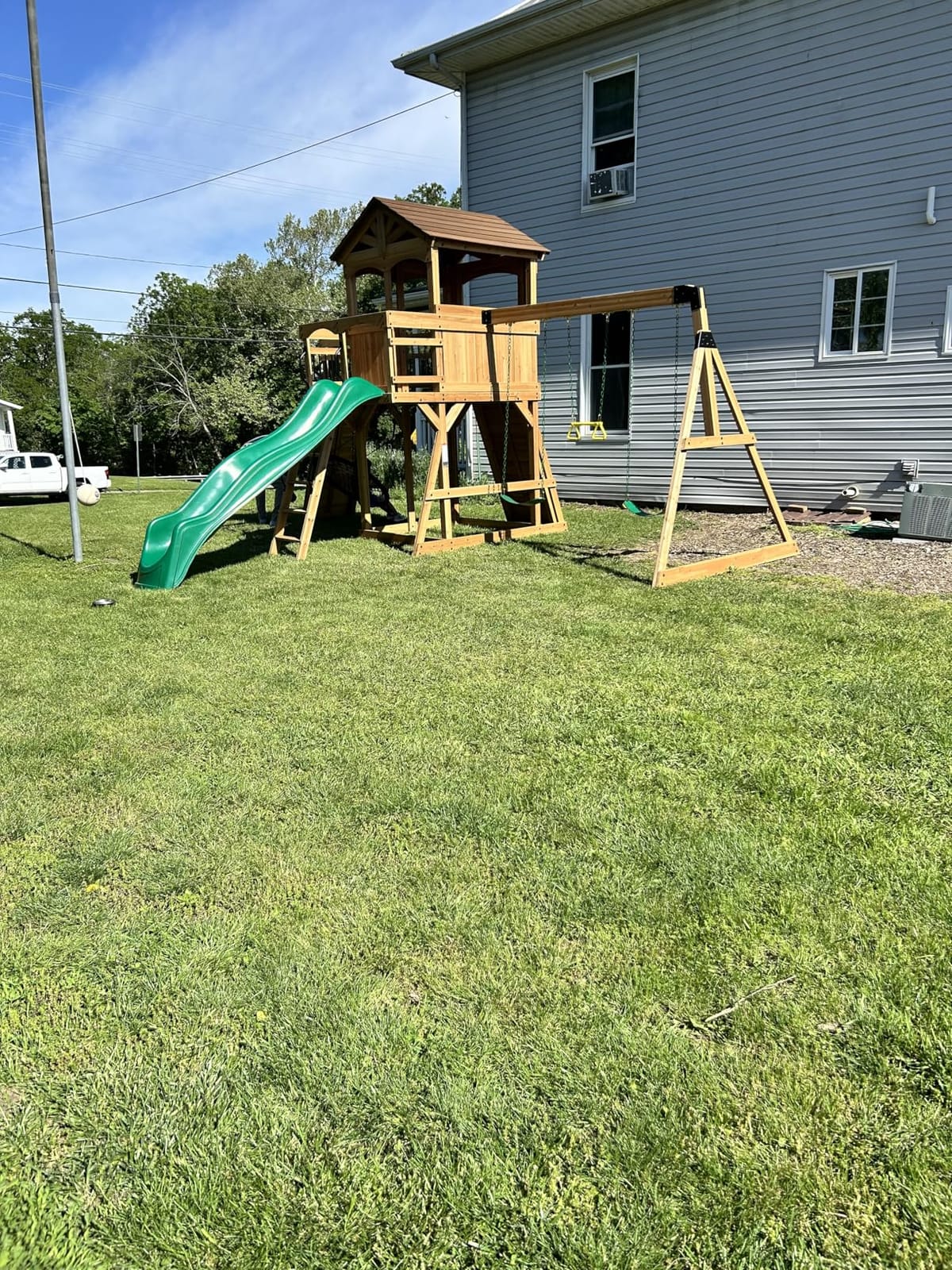Backyard Discovery Dover Bay Spruce Wood Swing Set with Spiral Tube Slide, Wave Slide, Clubhouse, Rock Wall, Belt Swings, Step Ladder, Toy Telescope, Chalkboard, Outdoor Playset customer photo 1